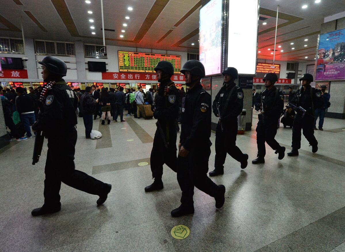 Chinese armed police patrol the scene of the terror attack at the main train station in Kunming, Yunnan Province.