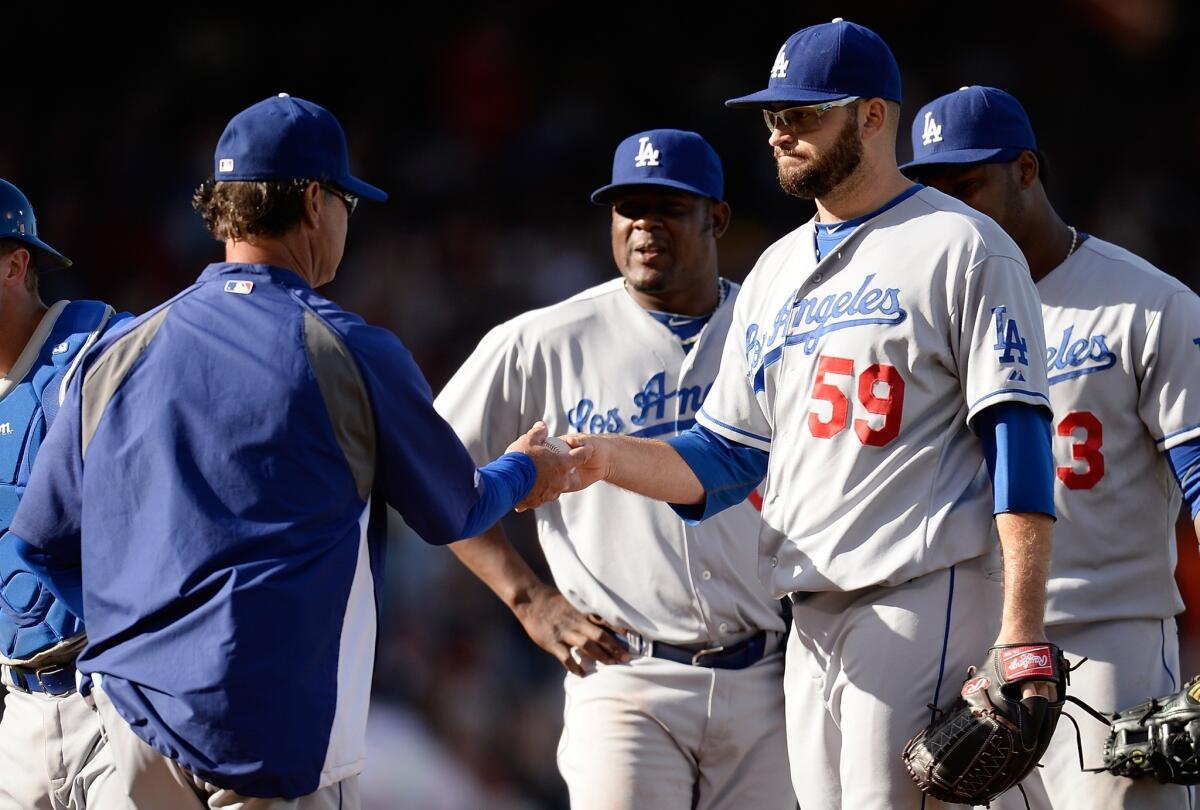 Dodgers starting pitcher Stephen Fife is pulled from the game by Manager Don Mattingly, left, in the fifth inning of Saturday's 4-2 loss to the San Francisco Giants.