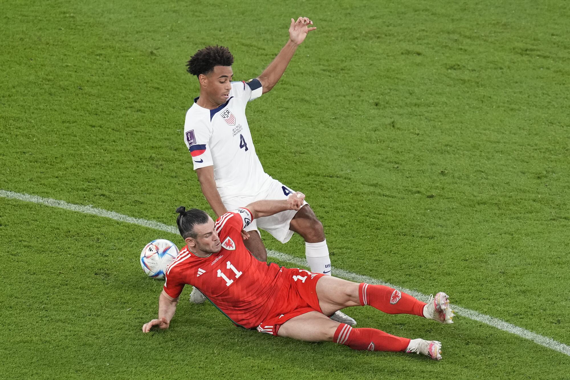Wales' Gareth Bale, bottom, challenges Tyler Adams.