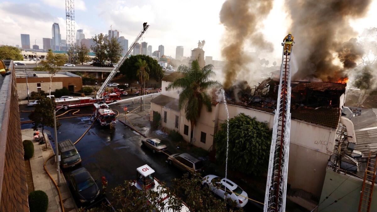 Firefighters work to extinguish a fire in an abandoned church building in the University Park area near downtown Los Angeles on Thursday morning.