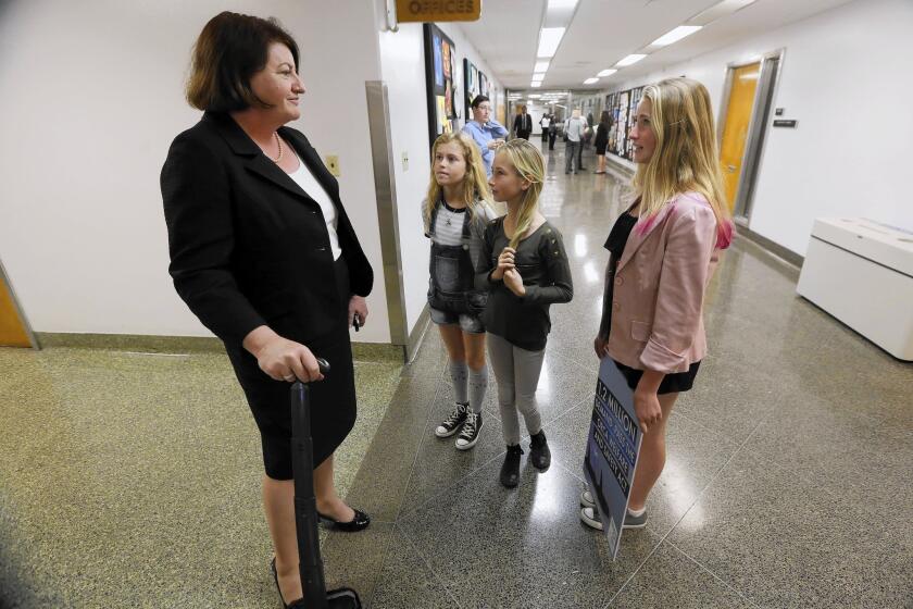Assembly Speaker-elect Toni Atkins listens to young constituents Lizzie Gordon, center, Kirra Kotler and Ava Kotler, who were urging her support for a bill to ban the use of killer whales for entertainment purposes.