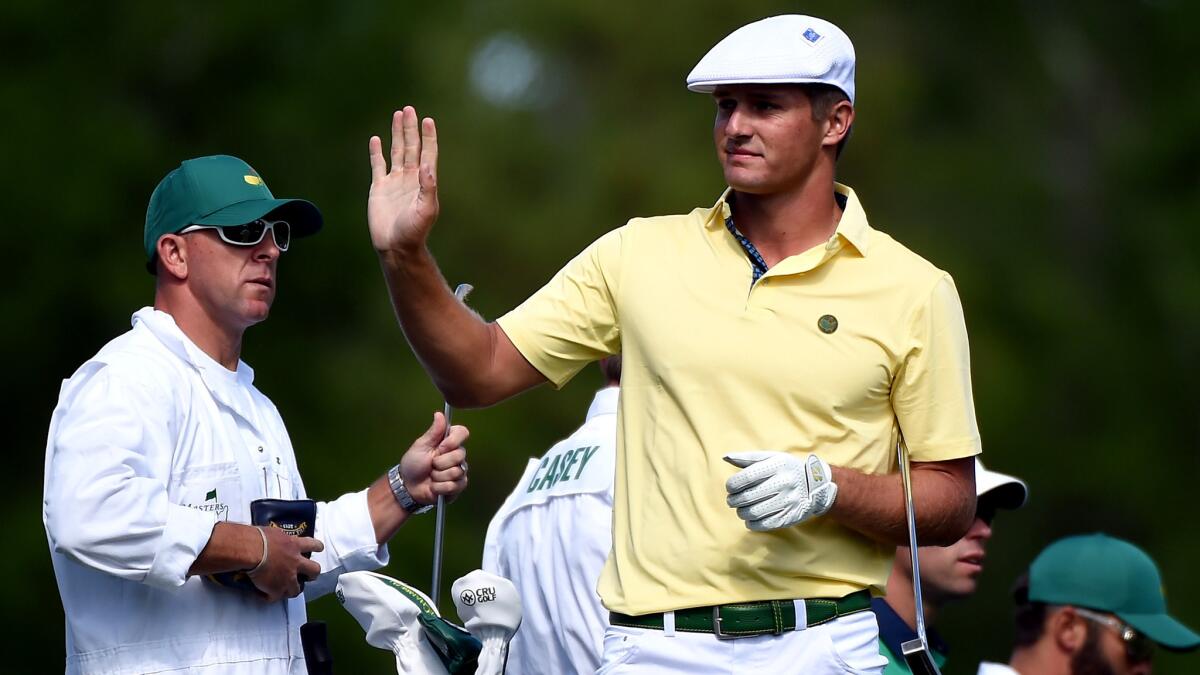 Bryson DeChambeau acknowledges the fans Friday after hitting a tee shot during the second round of the Masters.