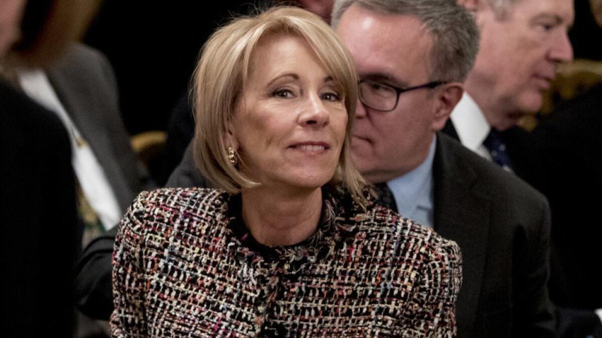 The Education Department is led by Betsy DeVos, shown Friday. The department found that Navient, one of the nation's largest student loan servicing companies, may have driven tens of thousands of borrowers struggling with their debts into higher-cost repayment plans.