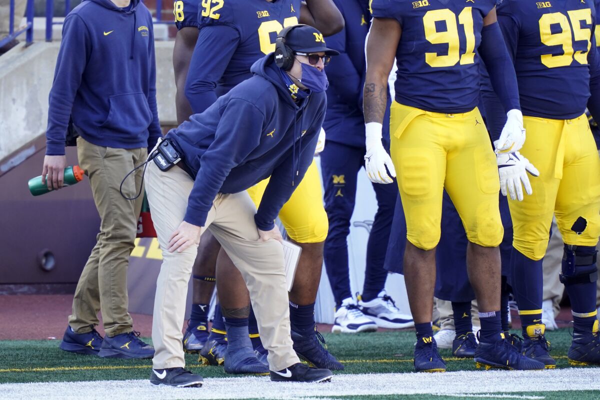 Michigan coach Jim Harbaugh watches from the sideline during the Wolverines' loss to Penn State on Saturday.