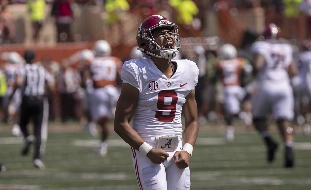 Alabama quarterback Bryce Young make fists and yells.