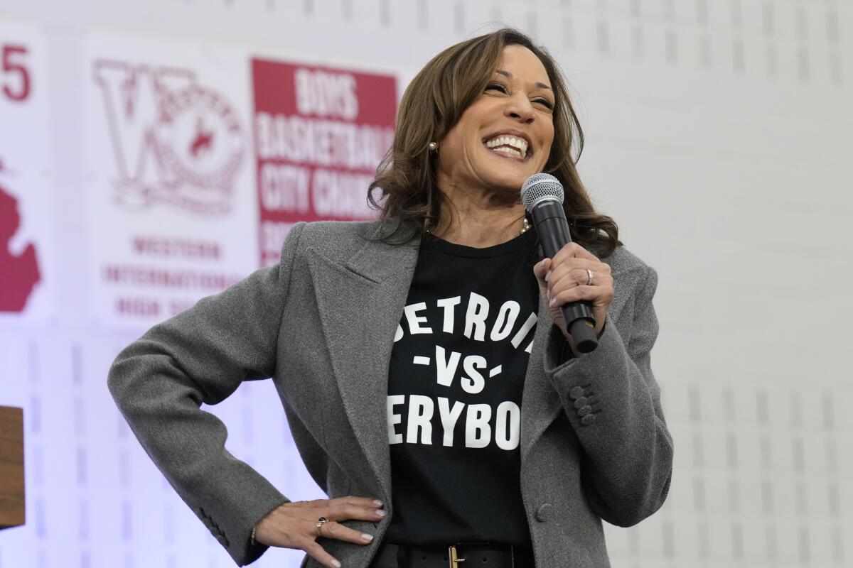 Vice President Kamala Harris speaks while wearing a blazer over a "Detroit vs Everybody" t-shirt.