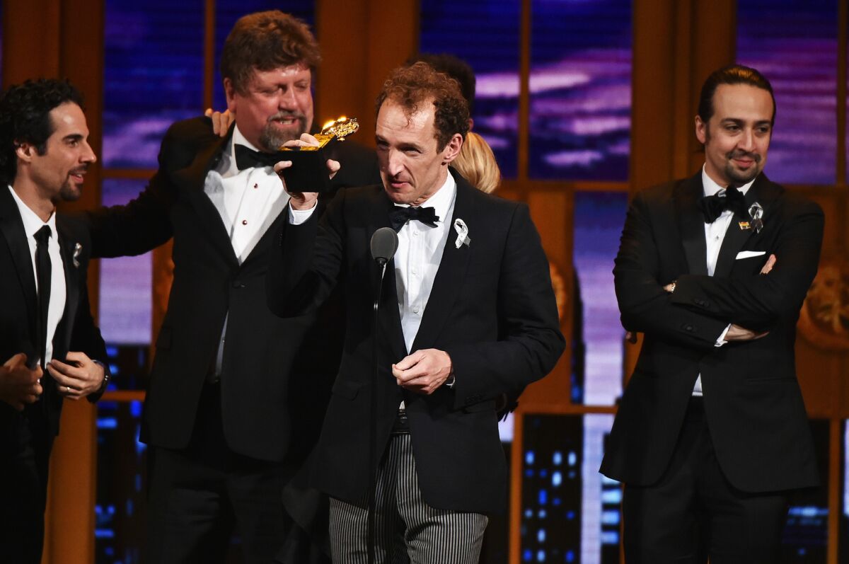 Producer Jeffrey Seller, center, accepts the Tony Award for best musical, presented to "Hamilton."
