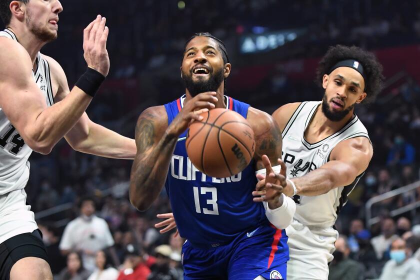 Pasadena, California November 16, 2021: Clippers Paul George is fouled by Spurs Derrick White, right, while driving to the basket as Drew Eubanks tries to help on defense in the 1st quarter at the Staples Center Tuesday. (Wally Skalij/Los Angeles Times)
