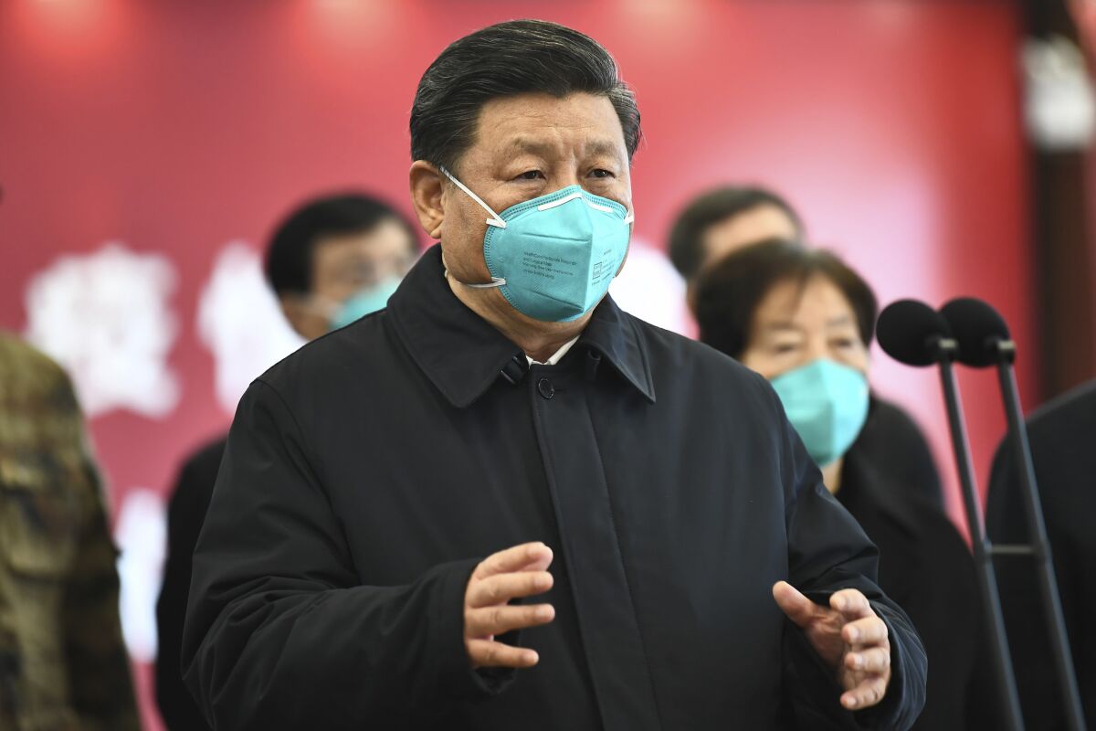 Chinese President Xi Jinping talks March 10 by video with patients and medical workers at the Huoshenshan Hospital in Wuhan.