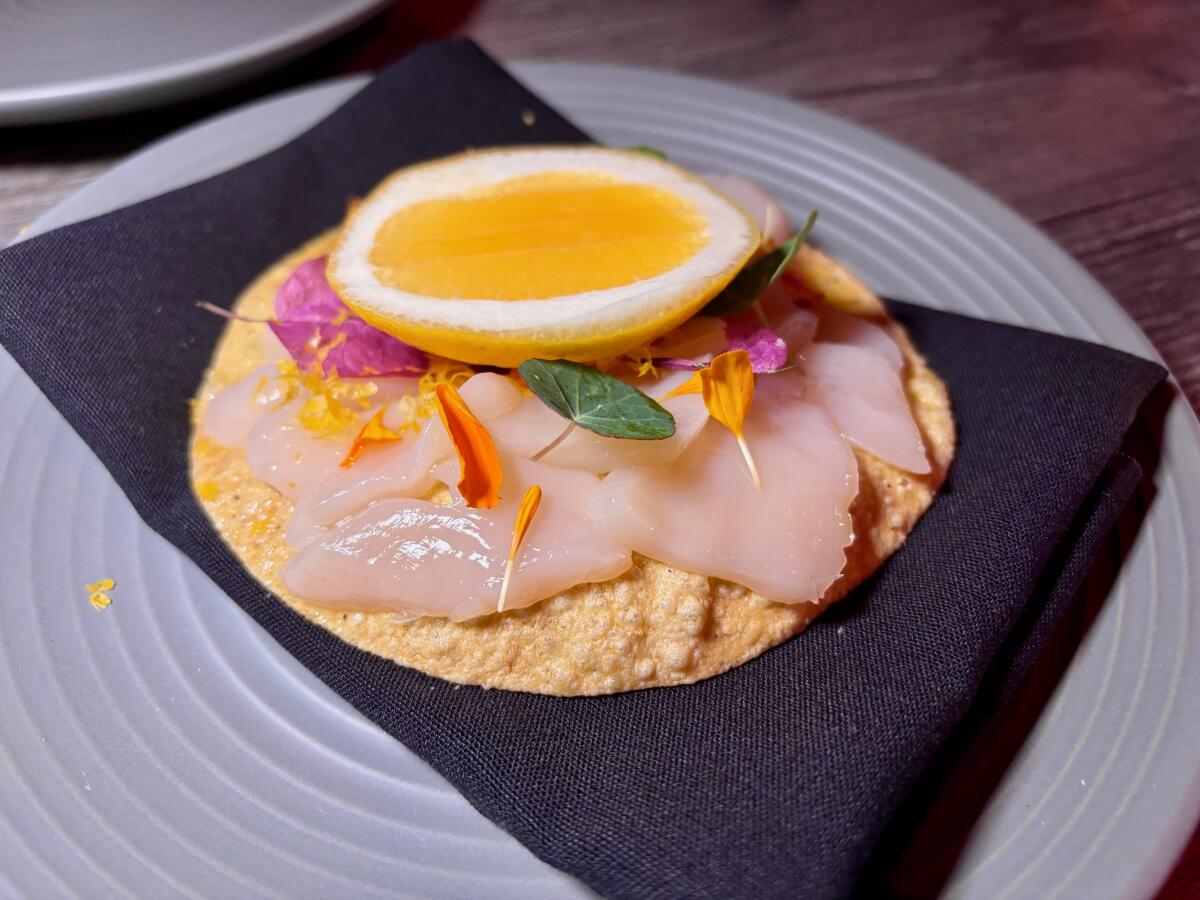 A scallop tostada at Darkroom in Santa Ana is served with Meyer lemon and marigold vinaigrette.