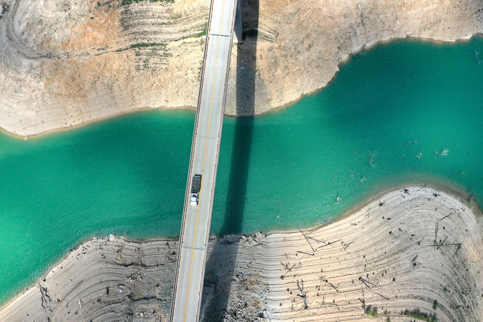 A truck drives on the Enterprise Bridge over a section of the lake.