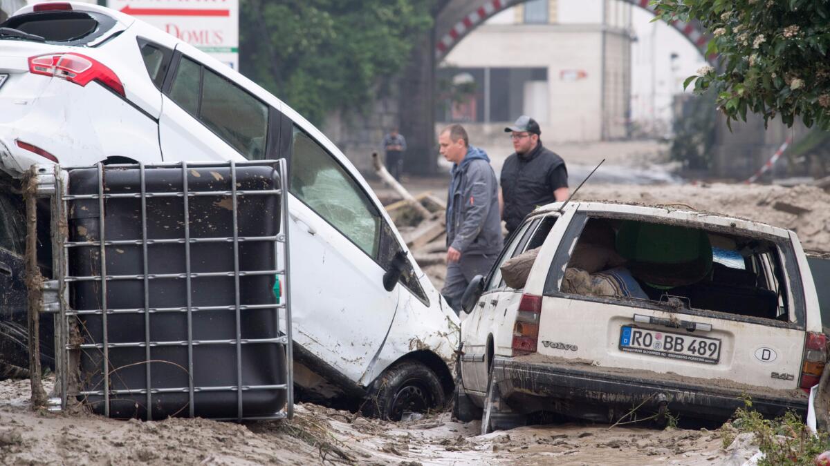 Cars stuck in a muddy street from flooding in the Bavaria region of Germany.