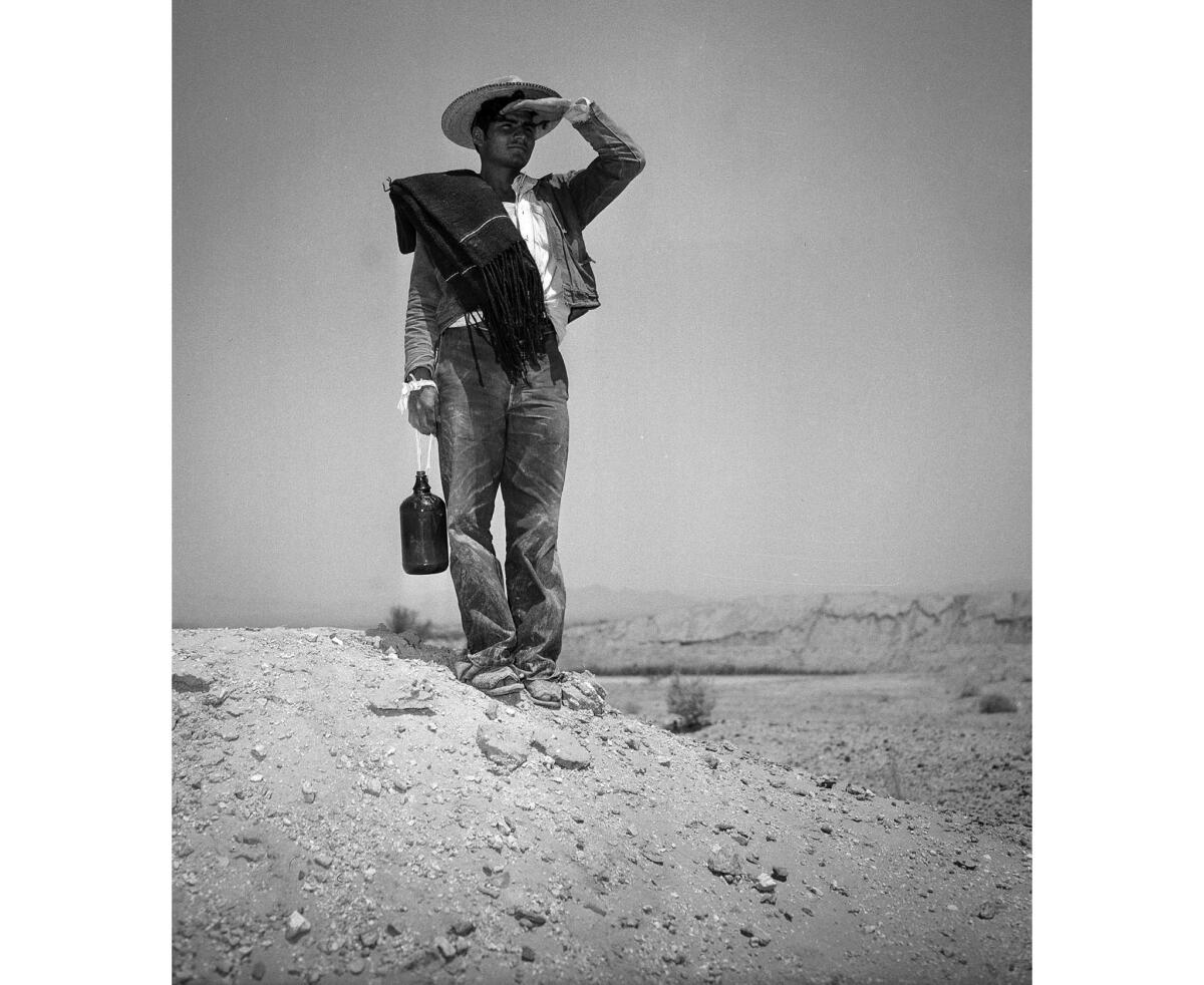 Pedro Gomez Mendoza, 25, looks north after being stopped by the Border Patrol. He had survived an 80-mile hike across the desert before being apprehended. This photo appeared in the May 3, 1950, Los Angeles Times.