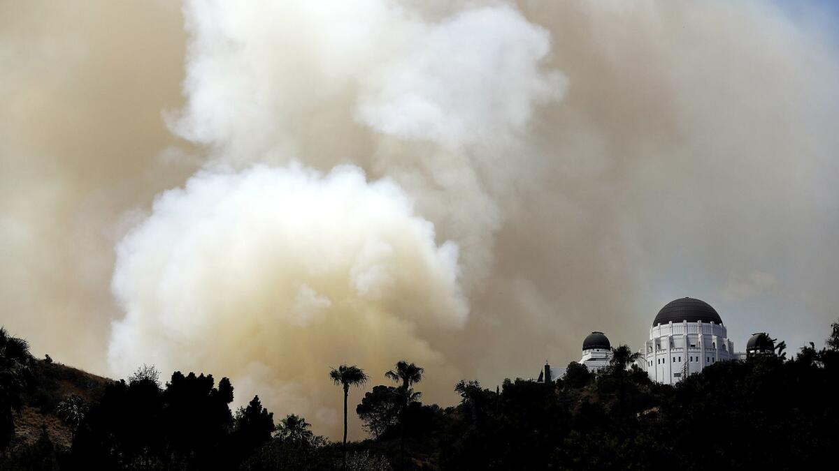Smoke rises from a July brush fire near Griffith Observatory in Griffith Park. Firefighters were called back to the park on Monday after a new blaze erupted.