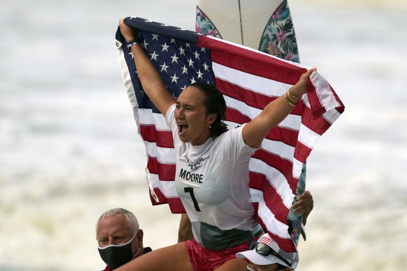 Carissa Moore, of the United States, celebrates winning the gold medal.