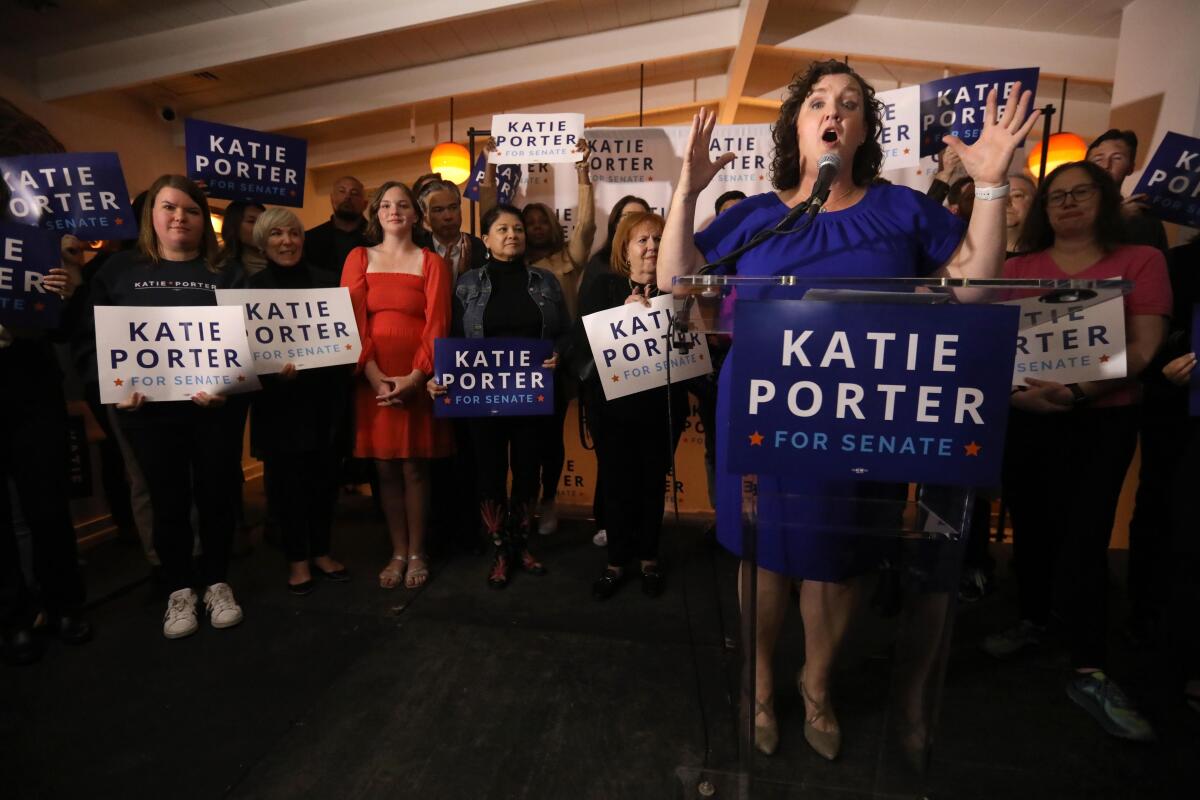 U.S. Representative Katie Porter applauds her daughter off camera, while she introduces her mother to supporters
