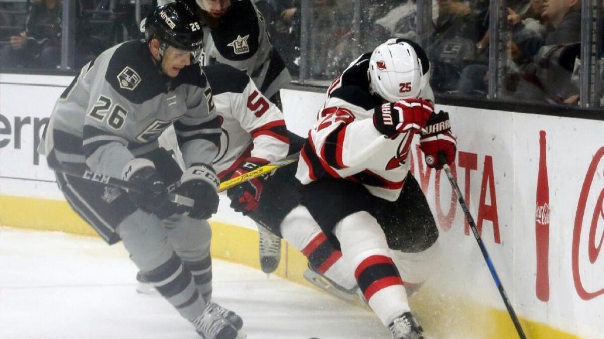 Kings forward Nic Dowd and Devils forward Devante Smith-Pelly battle for the puck during the first period of a game at Staples Center on Nov. 19.