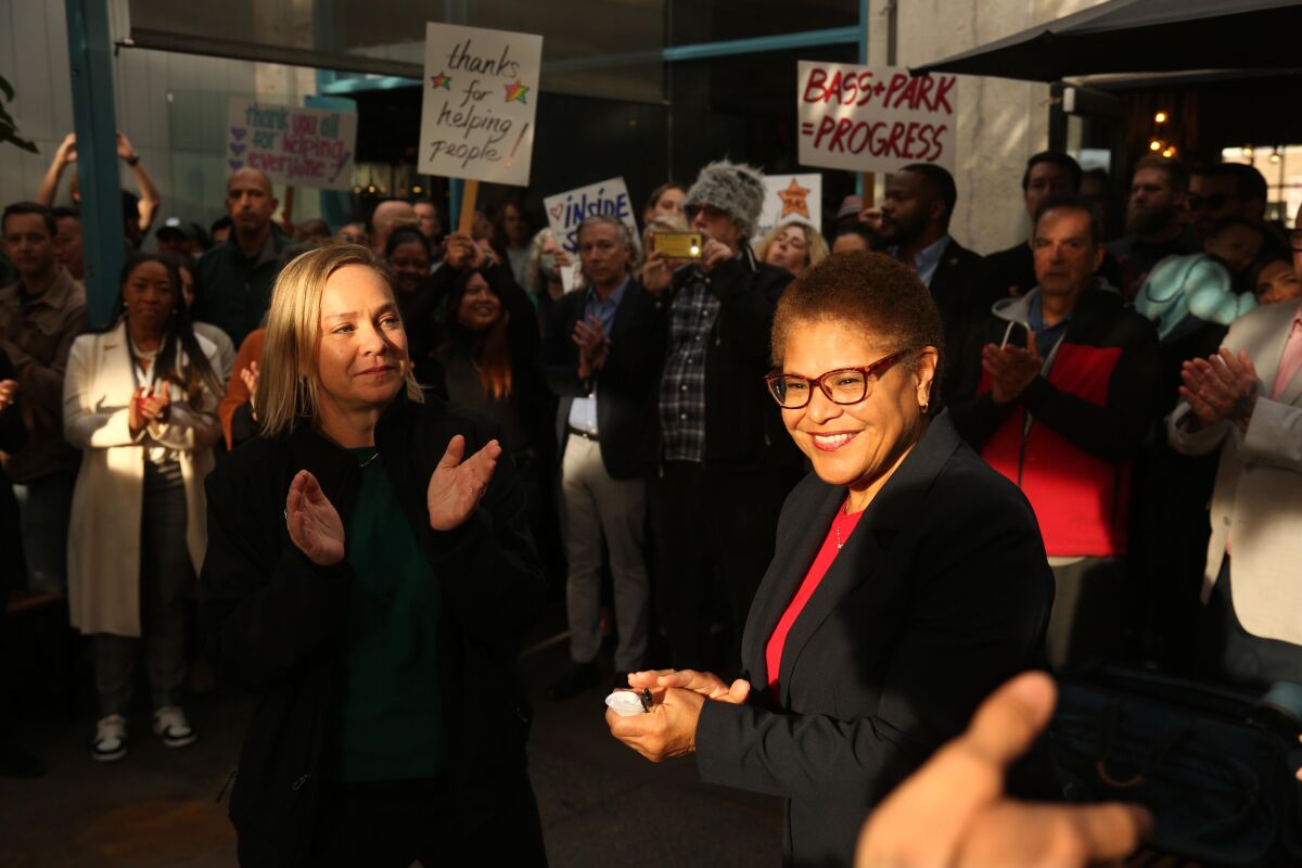 Los Angeles City Councilmember Traci Park, left, and residents of Venice applaud Los Angeles Mayor Karen Bass.