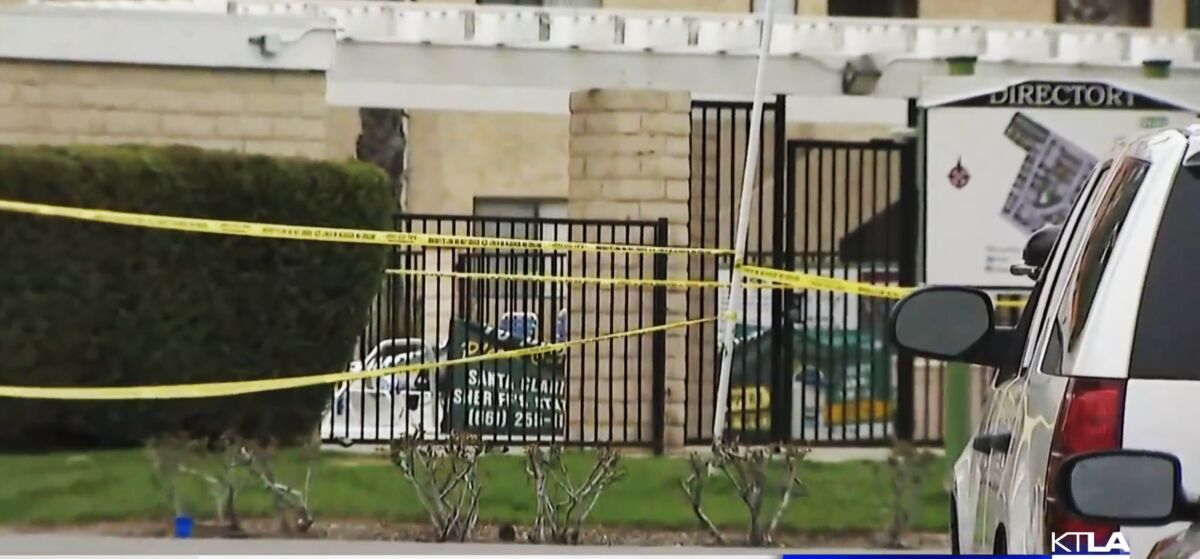 Crime scene tape at an apartment complex pool in Santa Clarita on Saturday.