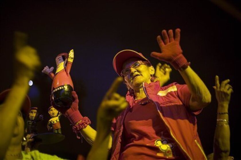 A supporter of Venezuela's President Hugo Chavez dances during a campaign rally ahead of regional elections in Caracas, Sunday, Nov. 16, 2008. The elections for gubernatorial and municipal posts on Sunday Nov. 23, will be key test of Chavez's support a year after Venezuelans handed him his first defeat by rejecting an attempt to abolish term limits. (AP Photo/Ariana Cubillos)