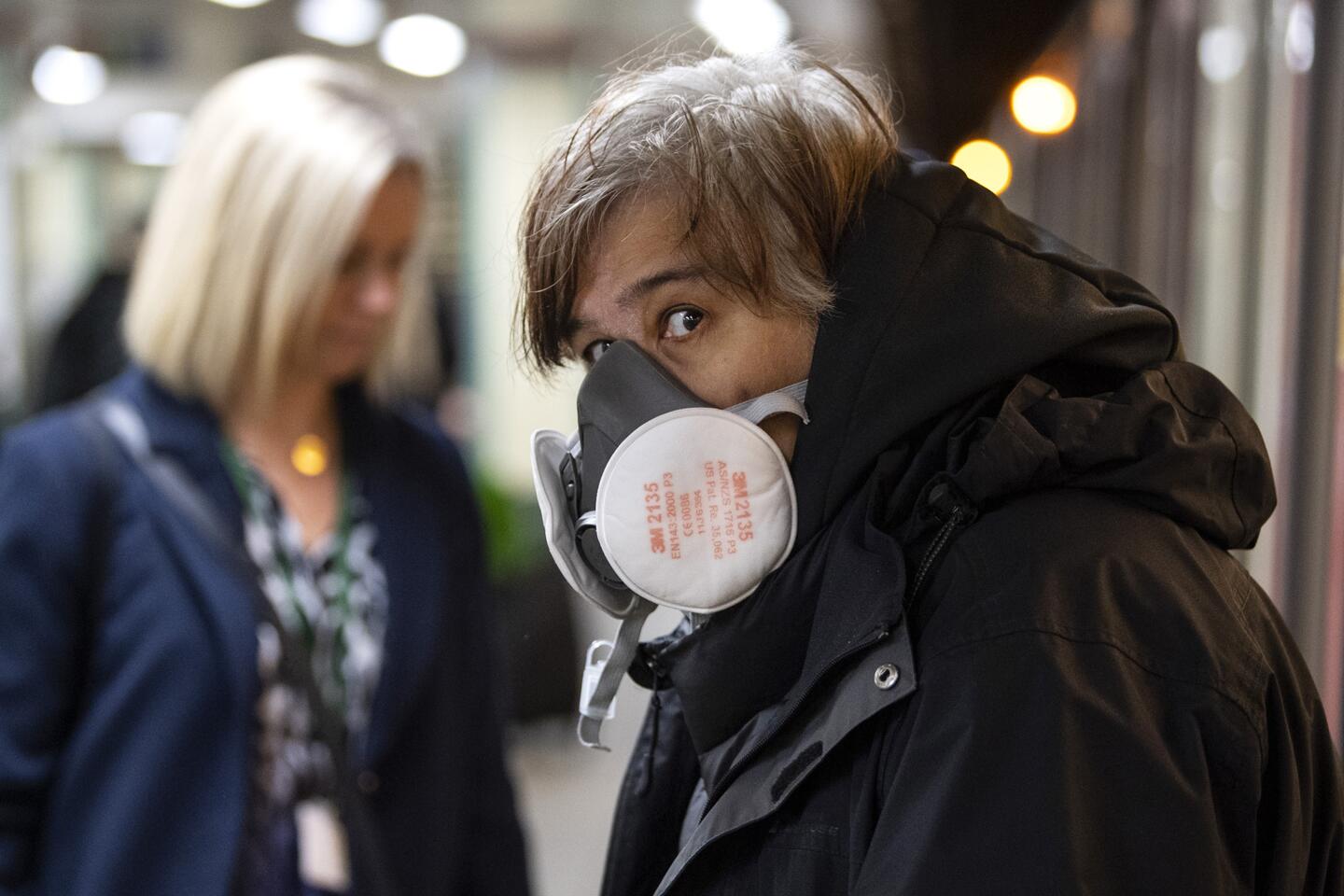 Britain: A commuter wearing a face protection mask travels on the Underground tubes.