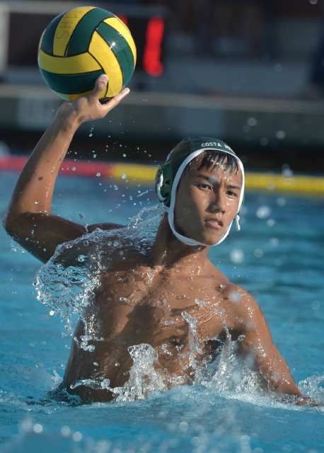 Quan Nguyen (4) of Costa Mesa leaps out of the water during the Battle for the Bell.