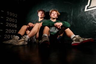 Poway, CA - January 17: Poway wrestlers and brothers Aliaksandr and Arseni Kikiniou pose for a photo at Poway High School on Wednesday, Jan. 17, 2024 in Poway, CA. (Meg McLaughlin / The San Diego Union-Tribune)