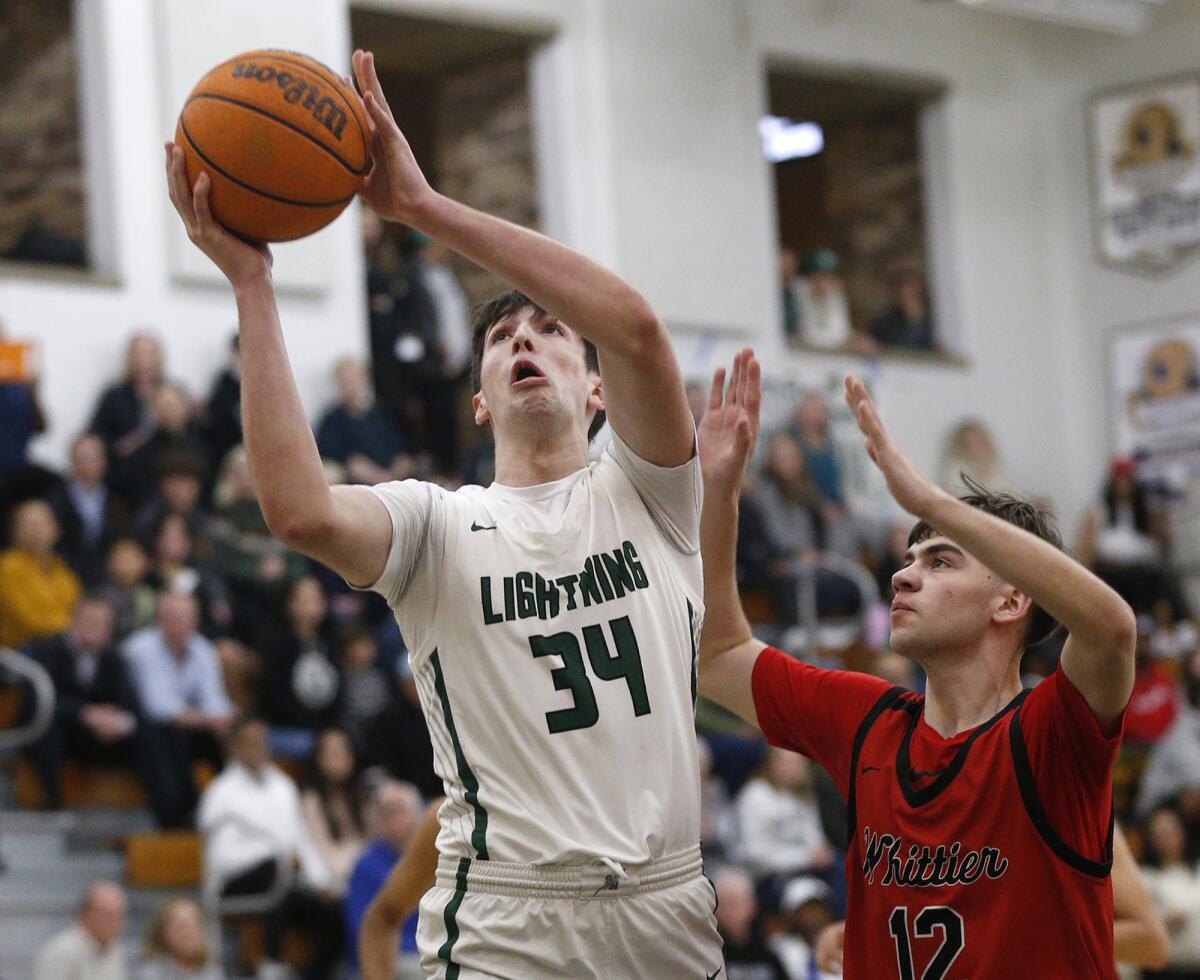 Sage Hill's Johnny Mayhew (34) drives for a layup against Whittier on Wednesday.
