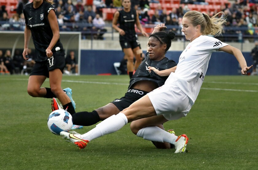 Angel City FC's Jasmyne Spencer, left, and San Diego Wave FC's Kelsey Turnbow fight for the ball