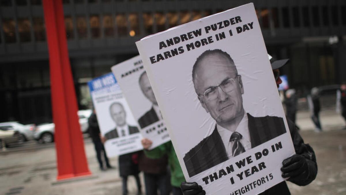 Fight for $15 workers in Chicago protest the nomination of Andy Puzder for Labor secretary.