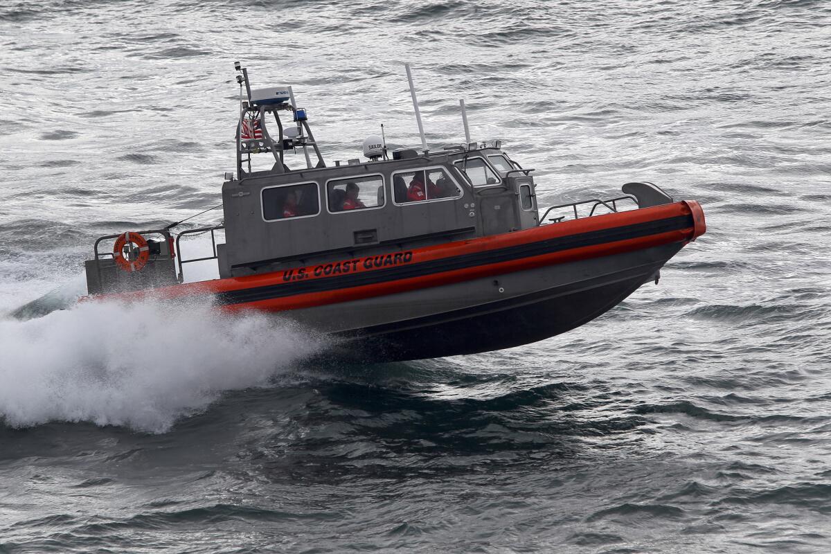 A U.S. Coast Guard multi-mission boat, the CB-OTH-4, plies the Arctic waters off the coast of Barrow, Alaska.