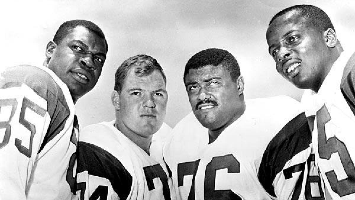 This photograph from 1964 shows the Los Angeles Rams' legendary defensive line known as the "Fearsome Foursome." From left: Lamar Lundy (85), Merlin Olsen (74), Rosey Grier (76) and Deacon Jones (75).