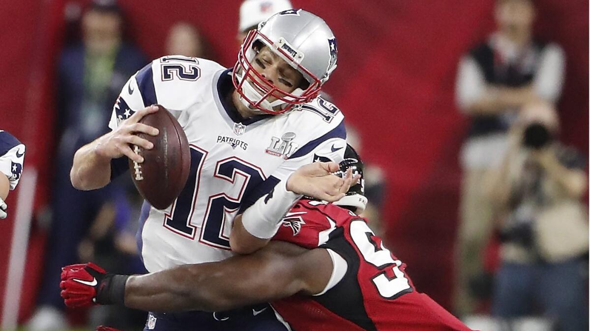 New England Patriots quarterback Tom Brady is sacked by Atlanta Falcons defensive end Courtney Upshaw during the first quarter