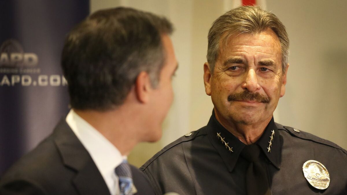 Mayor Eric Garcetti, left, looks at LAPD Chief Charlie Beck after Beck's surprise retirement announcement in January. Beck, who became L.A.'s police chief in 2009, will retire in June.