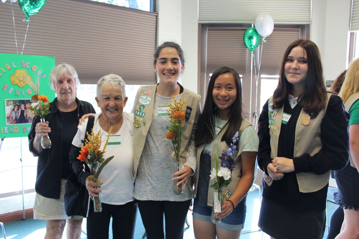 Rancho Santa Fe Girl Scouts Maira Clotfelter, Chloe Luwa and Jewel Perry connected with local seniors on Friendship Day.