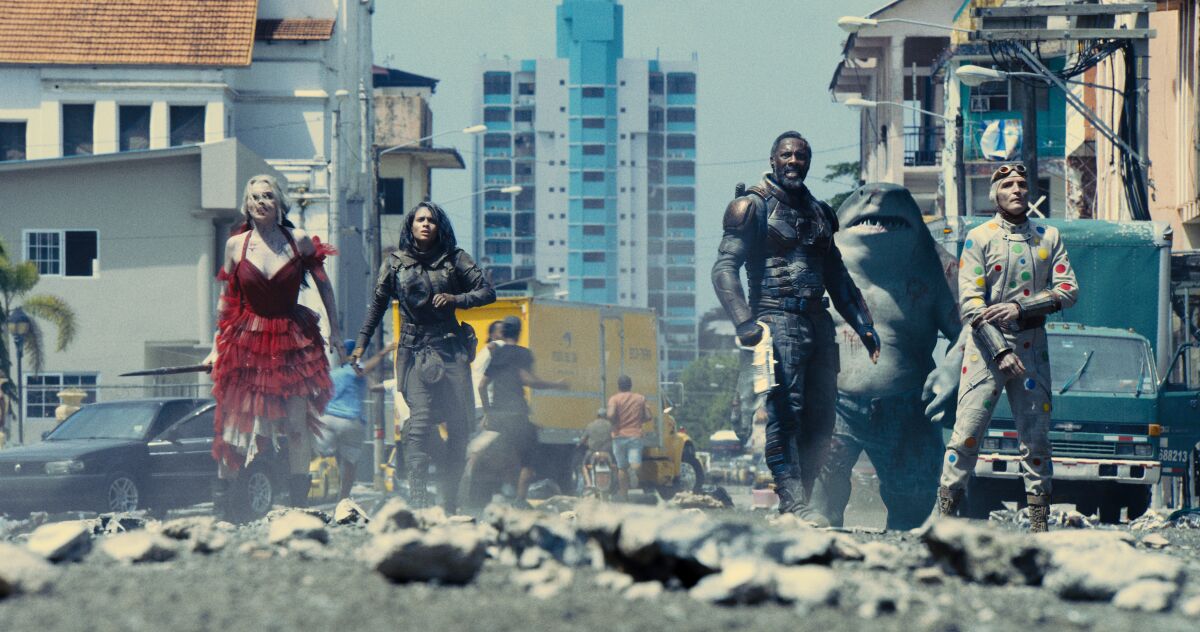 “The Suicide Squad,” a team of supervillains, stands amid city rubble.