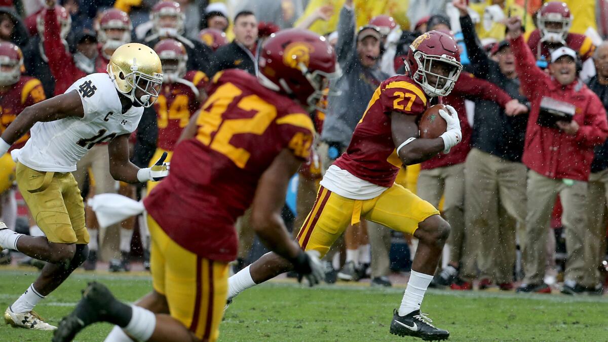 USC defensive back Ajene Harris returns an interception for a touchdown against Notre Dame during the second quarter Saturday.