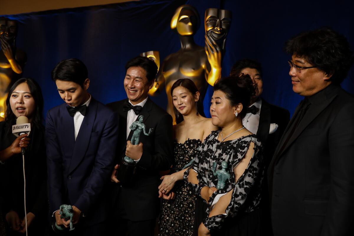 "Parasite" actors Choi Woo Shik, Lee Sun Kyun, Park So Dam, Lee Jeong Eun, Song Kang Ho and filmmaker Bong Joon Ho backstage at the SAG Awards.