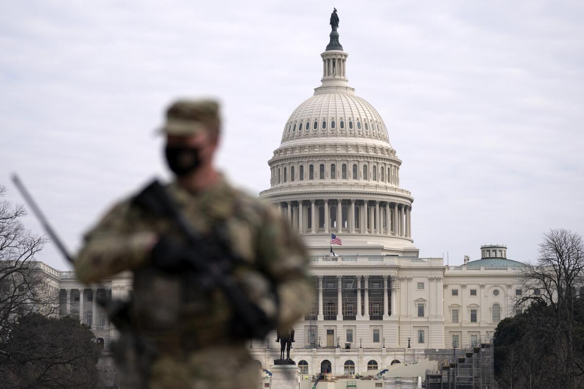 A member of the National Guard patrols the area outside of the U.S. Capitol at the Capitol in Washington.