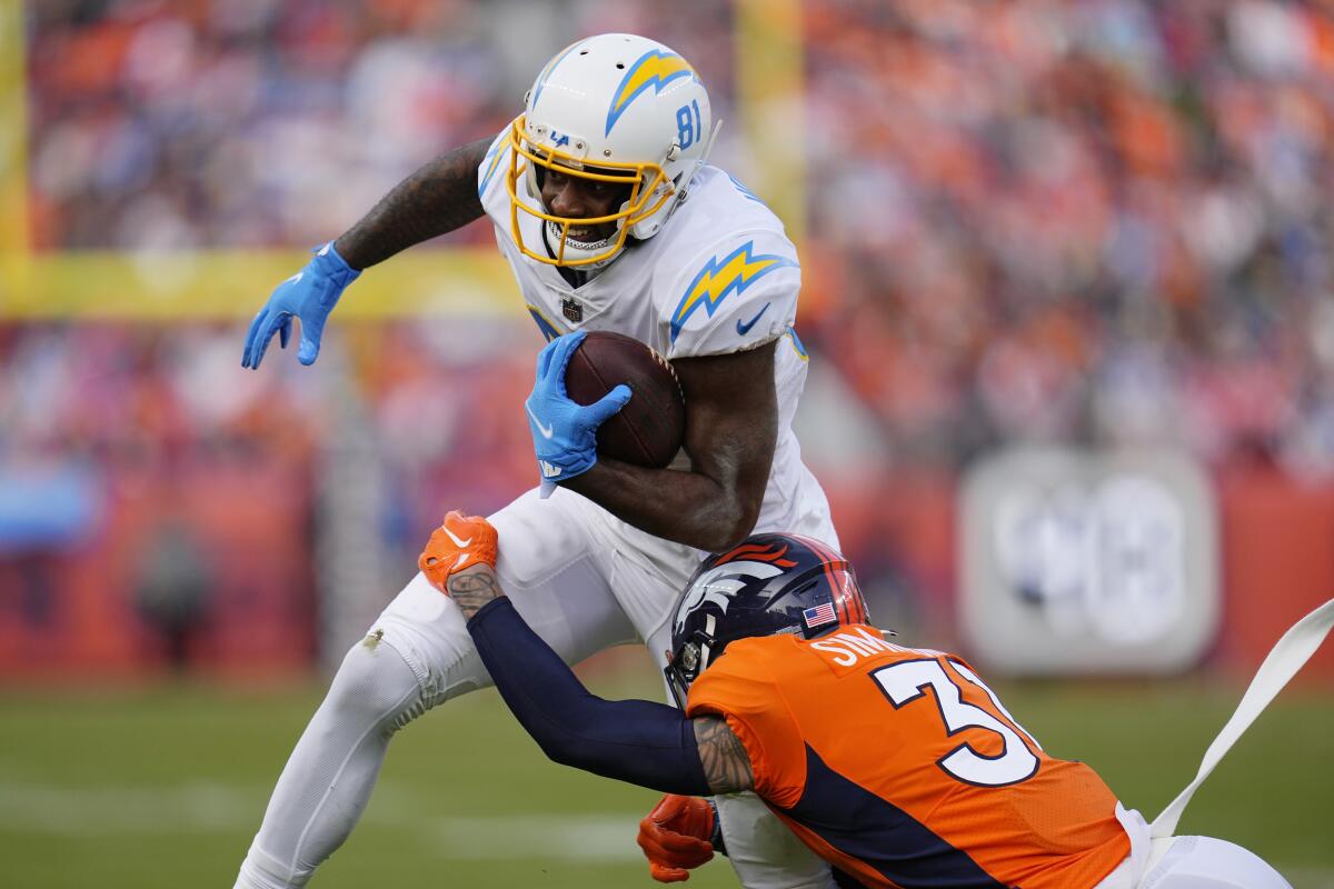 Chargers wide receiver Mike Williams is hit by Denver Broncos safety Justin Simmons.