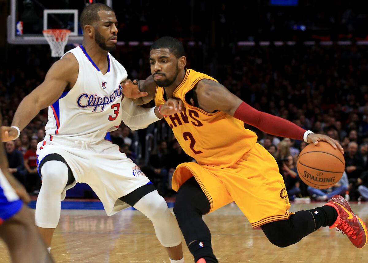 Clippers point guard Chris Paul tries to cut off a drive by Cavaliers point guard Kyrie Irving in the third quarter.
