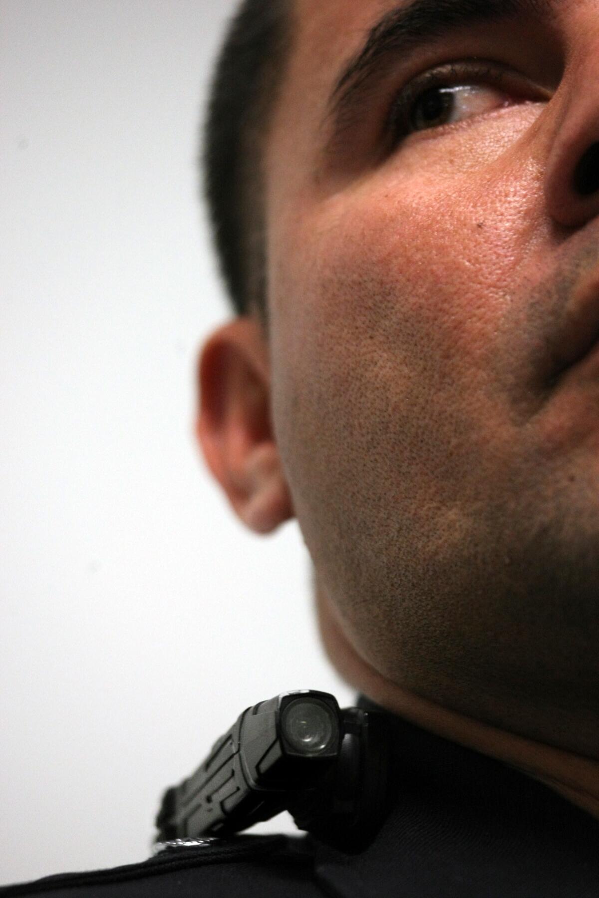 A Los Angeles police officer wears a Taser Axon clip-on camera on his collar at a press conference Wednesday. Police officials announced 30 volunteer officers had begun testing the cameras as part of a pilot program.