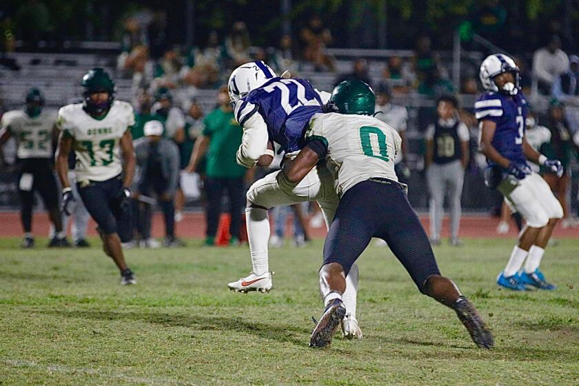 SEPTEMBER 7, 2023: Narbonne linebacker Mark Iheanachor tackles Venice receiver Ryan Watson in the fourth quarter. (Steve Galluzzo / For The Times)