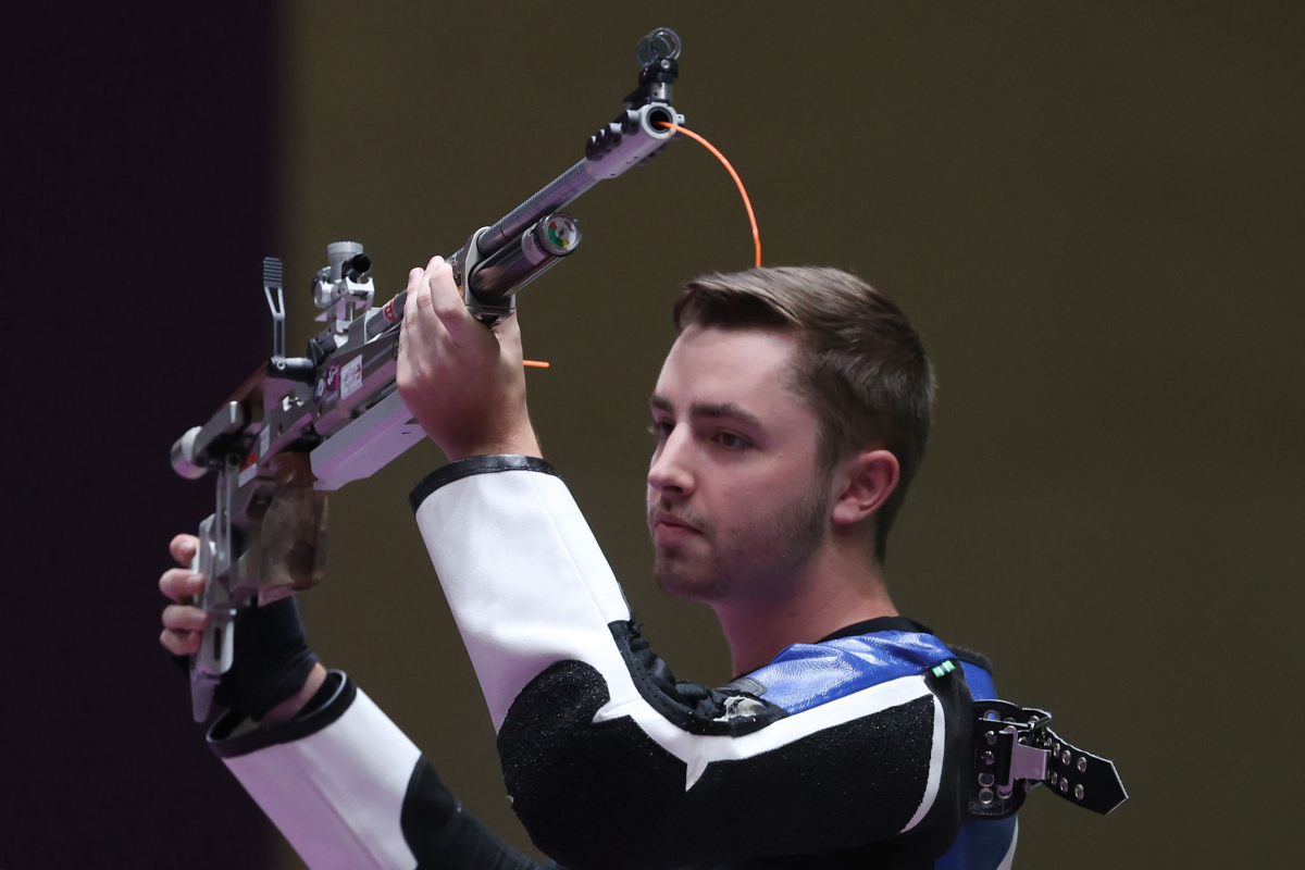 William Shaner of Team United States raises his rifle after winning gold.