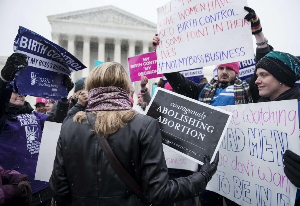 Protesters on both sides make their feelings clear at the Supreme Court as justices debate their decision in the Hobby Lobby case in March.