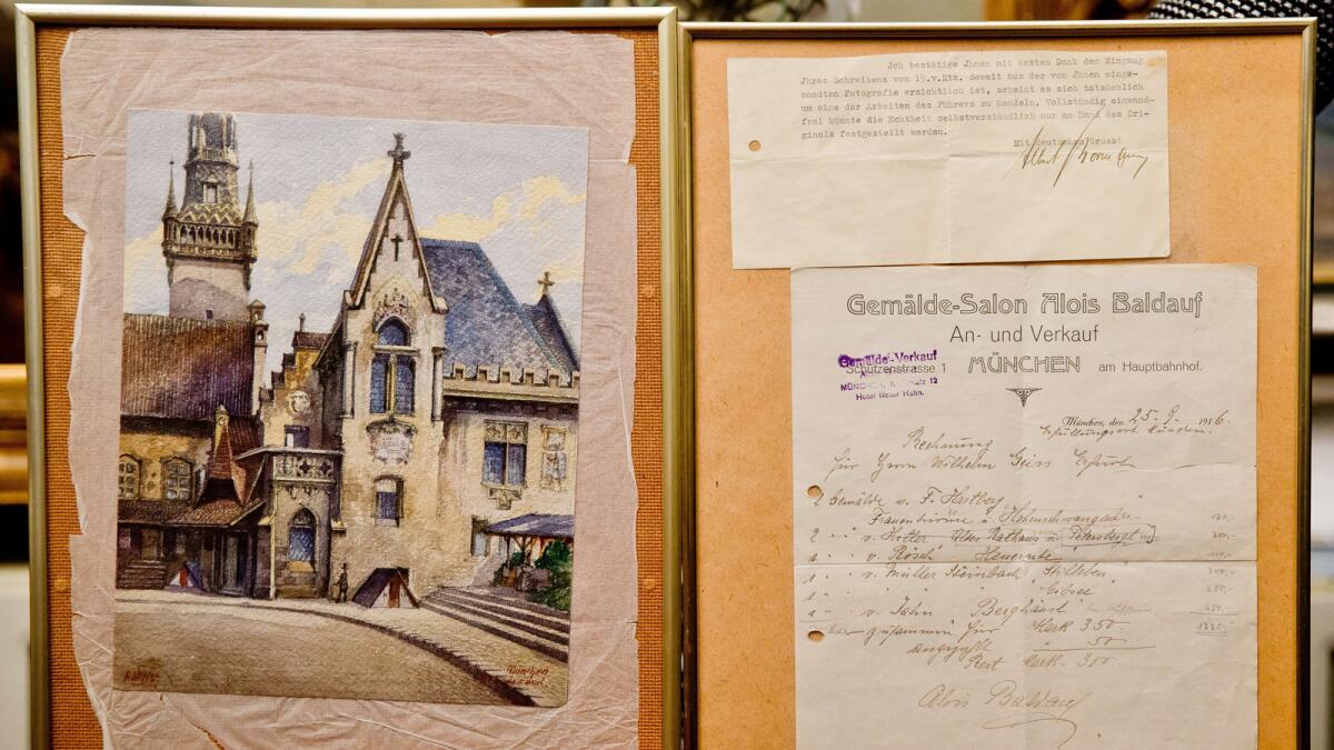 A picture taken Nov. 20 shows the 1914 watercolor "Altes Rathaus" of the old city hall in Munich attributed to Adolf Hitler, the original invoice for the painting from 1916 and a letter by Hitler's adjutant Albert Bormann.