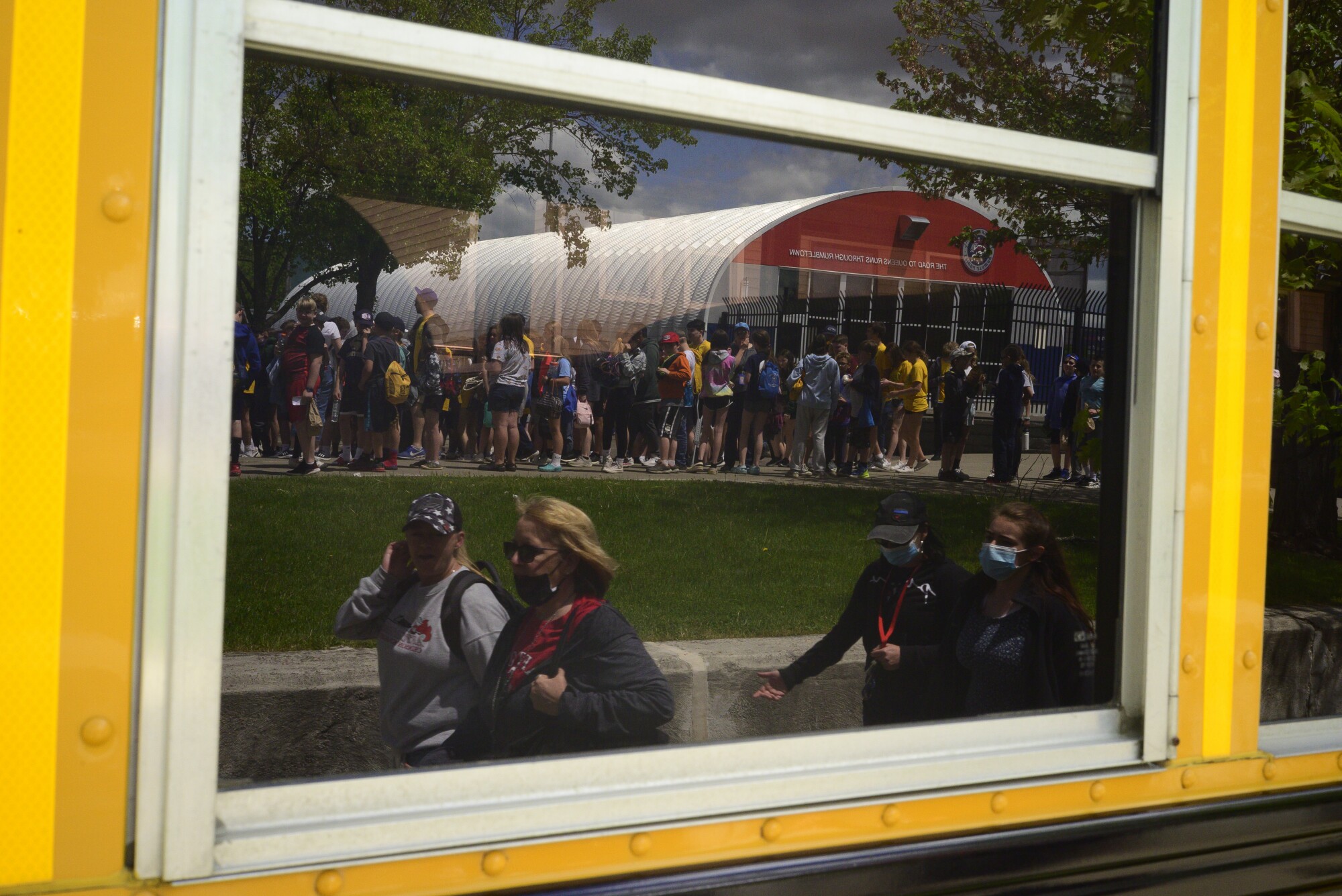 People are reflected in a window.