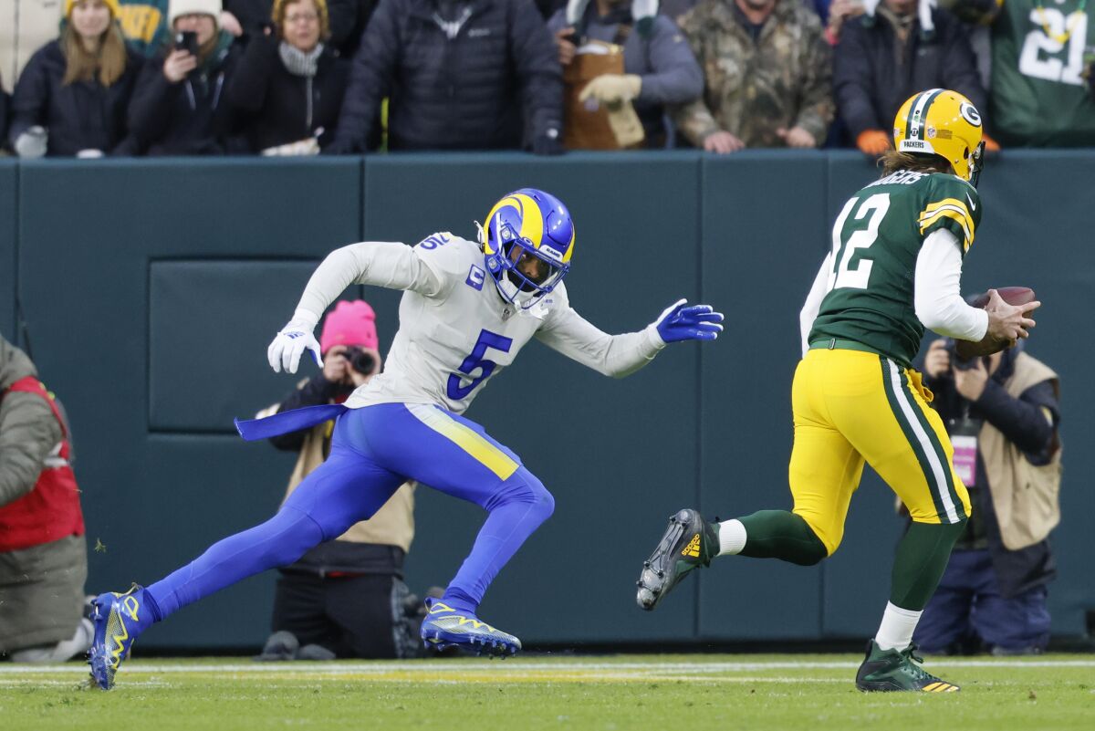 Packers quarterback Aaron Rodgers outraces Rams cornerback Jalen Ramsey (5) to the corner of the end zone for a touchdown.