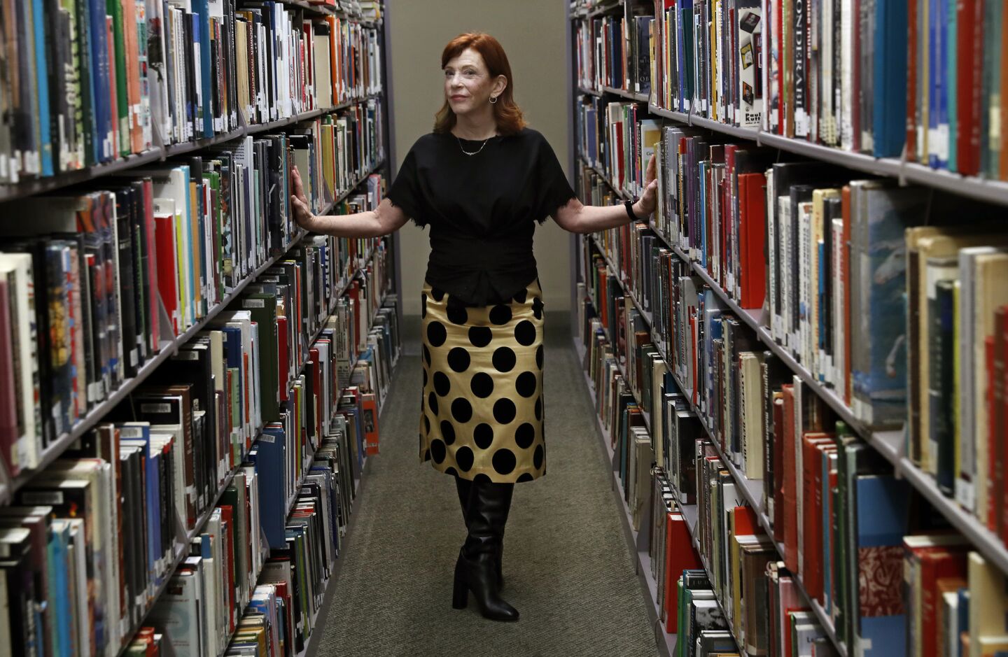 Susan Orlean pauses in the arts and music section at the Los Angeles Central Library.