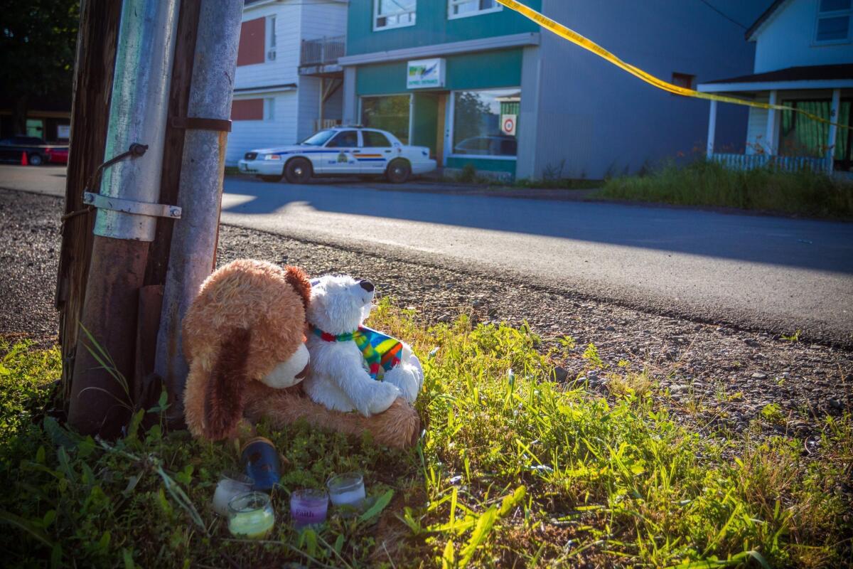 A memorial sits outside the Reptile Ocean exotic pet store in Campbellton, New Brunswick. Two boys are believed to have been killed by a python in an apartment above the store.